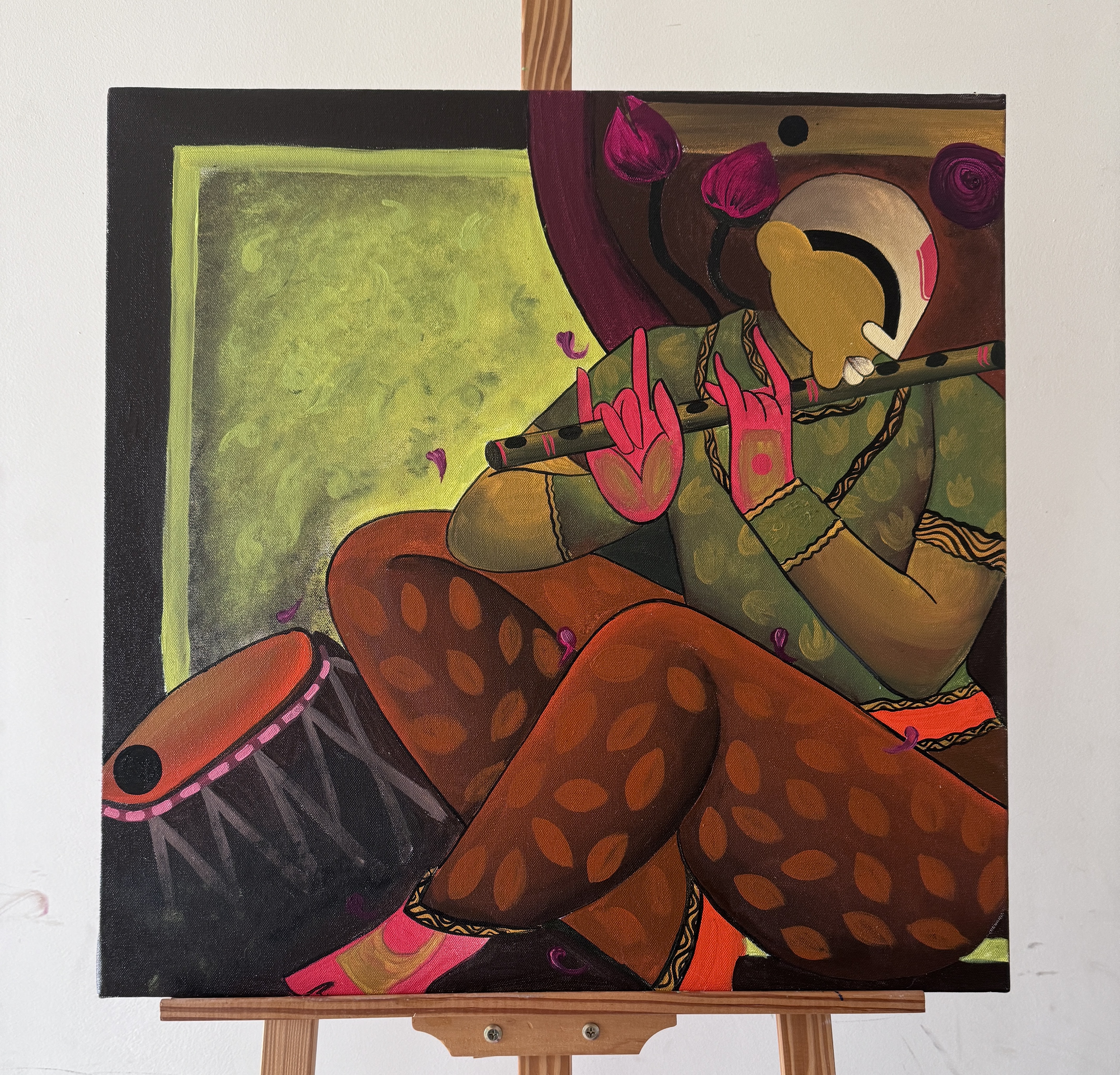 A blue-toned Buddha painting resting on a studio easel