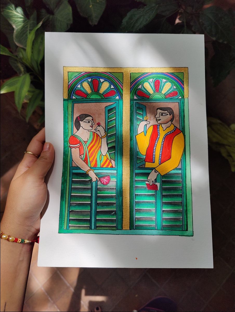 A hand holding a painted window study