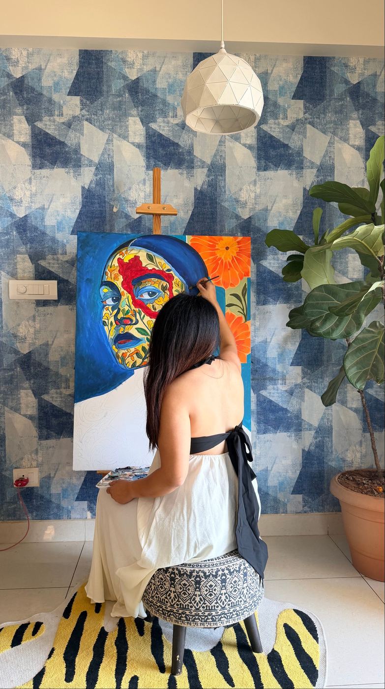 Rucha at work on a blue portrait