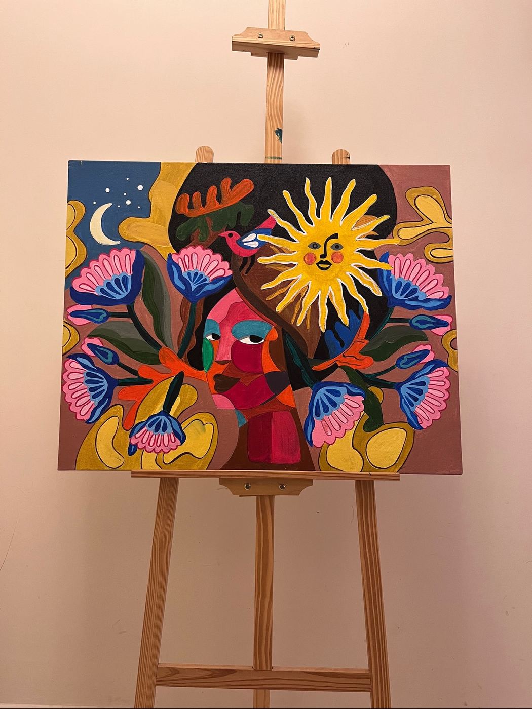 A sun and floral painting on an easel