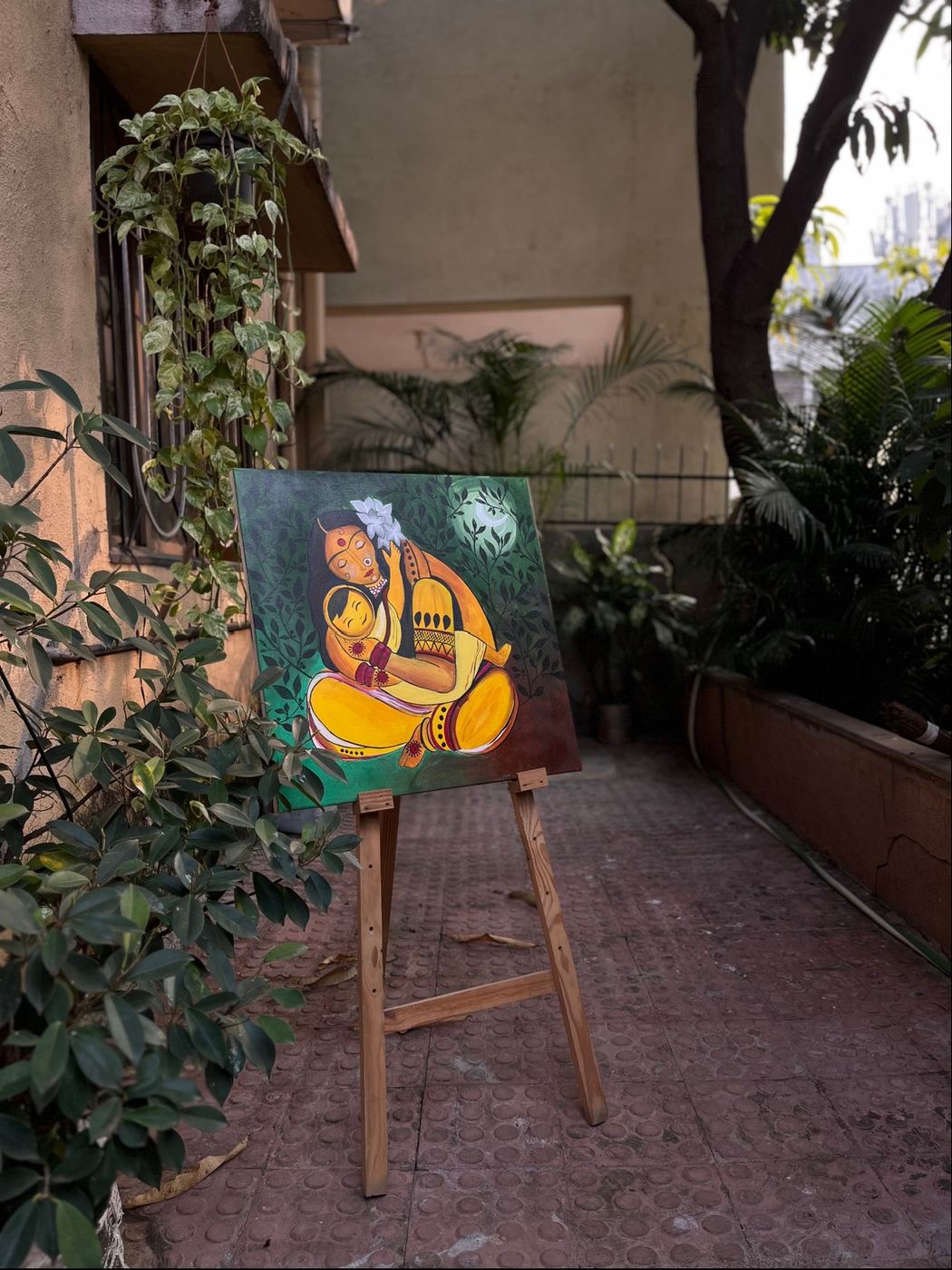 The same painting resting on an easel outdoors
